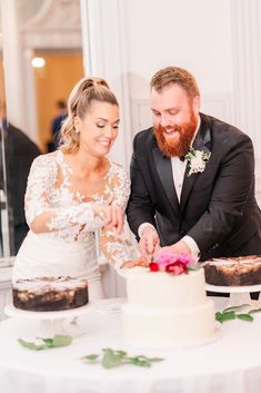 a bride and groom cutting their wedding cake