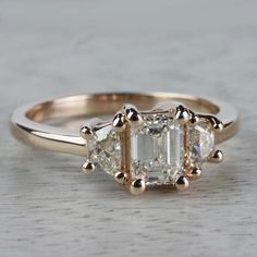 an engagement ring with three stones on it