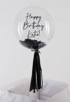 a clear balloon with the words happy birthday kate on it