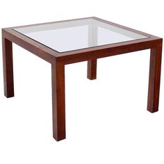 a glass table with wooden legs on a white background