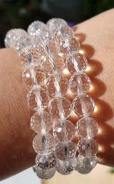 This listing is for 1, Beautiful Facet Quartz Crystal Bracelet. Perfect for stacking, along side a watch or by itself. Absolutely stunning sparkle with every turn! Great gift or addition for your own collection. 🌐METAPHYSICAL PROPERTIES, LORE, USES: Clear Quartz is often used to cleanse, open, activate, and align all of the chakras. Since Clear Quartz absorbs energies very easily, it is important to clear these stones on a regular basis. In natural form, Clear Quartz Points radiate their energi Sparkling Crystal Round Bracelet, Sparkling Round Crystal Bracelet, Adjustable Faceted Crystal Bracelet, Adjustable Faceted Round Crystal Bracelet, Adjustable Faceted Bracelet, Adjustable Round Crystal Bracelets, Adjustable Round Faceted Bracelet, Adjustable Clear Bangle Jewelry, Adjustable Clear Bangle Bracelet