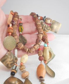 This Boho Tribal necklace has it all with hand carved wood beads, real pearls, end hammered real brass dangles, glass beads, bone beads, and all kinds of wood beads with a long strand in the center and graduated length strands on each side measures 17 inches from end to end with a brass spring roll clasp has many kinds and shapes beads...and colors is linked and connected with brass findings is quite the beauty! there was a lot of it to capture in pics, so they do not do this necklace justice If Peace Sign Necklace, Goth Necklace, Necklace Wood, Dangle Necklace, Spring Roll, Halloween Necklace, Dangle Necklaces, Skull Necklace, Bone Beads