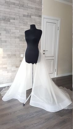 a mannequin wearing a wedding dress and veil