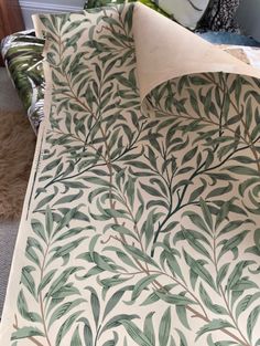 the bed is made with green leaves on it