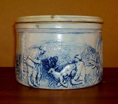 a blue and white container sitting on top of a wooden table