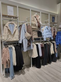 clothes and jackets are on display in the store