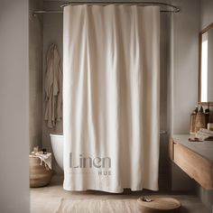 a white shower curtain in a bathroom next to a sink