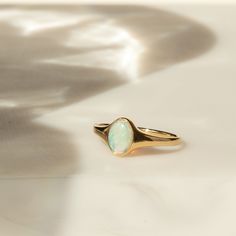 Meet your new favorite statement ring - the Opal Signet Ring. With just the right amount of sparkle and flash, this Australian opal ring makes a gorgeous statement by itself - or paired with your favorite stacked rings. It's made of 14k solid gold, so it'll last many lifetimes. After you're done with it, you can pass it on as an heirloom! DETAILS 14k solid gold ring 5mm x 7mm Australian opal Available in sizes 5-8 Weight: 1.5g Safe for sensitive skin & shower safe Matching jewelry: Oval Opal Nec