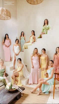 a group of women in dresses posing for a photo with one woman sitting on a chair