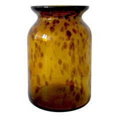 a yellow vase with brown spots on it