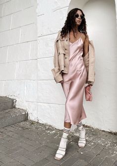 Pink silk dress outfit casual with denim jacket | Silk slip dress outfit street styles Slip Dress Hoodie Outfit, Pink And Neutral Outfit, Slip Dress Outfit Street Styles, Silk Slip Dress Outfit Street Styles, Pink Silk Dress Outfit, Satin Slip Dress Outfit Casual, Pink Slip Dress Outfit, Satin Dress Outfit Casual, Silk Dress Outfit Casual