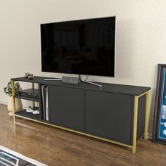 a flat screen tv sitting on top of a wooden entertainment center