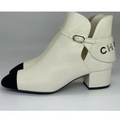 Nwt Chanel Signature Logo Ankle Boots Ivory/Gold Sz 38 Us 8 Perfect. Lambskin. In Box. Never Worn. Chanel 2021 (21a Season) Ivory Lambskin Leather Booties Have A Black Velvet Cap Toe And A Goldtone Chanel Signature On The Back. Chanel Embossed Buckle. 1.5" Leather Covered Block Heel. Padded Leather Insole. Leather Sole. Shaft: 4.5". Made In Italy. Designer Color: Ivory/Black. Classic Beige Ankle Boots, Beige Ankle Boots For Formal Occasions, Formal Beige Ankle Boots, Beige Leather Low Heel Booties, Classic Beige Boots With Reinforced Heel, Cream Pointed-toe Calf Leather Boots, Beige Low Heel Boots With Leather Sole, Beige Leather Booties With Low Heel, Cream Leather Boots With Reinforced Heel