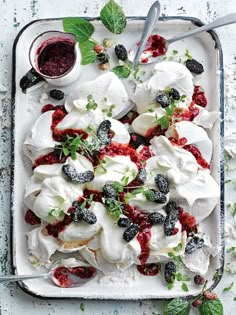 a platter filled with fruit and whipped cream