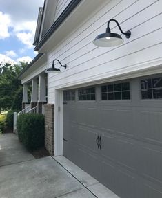 a garage with two lights on the side of it