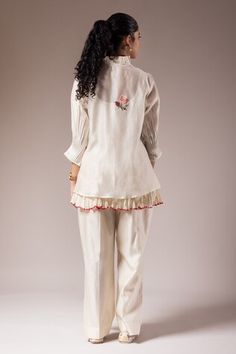 White shirt style top with pleated collar and maala style embroidery. Paired with a small cotton crushed inner and cotton flared pant. - Aza Fashions Cotton Blouse With Embroidered Cuffs, Embroidered Cotton Pant Set With Long Sleeves, Elegant Cotton Tops With Embroidered Cuffs, Cotton Top With Embroidered Cuffs For Work, Cotton Tops With Embroidered Cuffs For Work, Cotton Blouse With Embroidered Cuffs For Work, Elegant Cotton Blouse With Embroidered Cuffs, Cotton Tops With Pintucks And Relaxed Fit, Relaxed Fit Cotton Tops With Pintucks