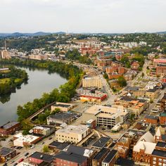 an aerial view of a city with lots of buildings and water in the middle of it