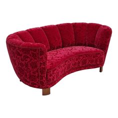 a red couch sitting on top of a white floor