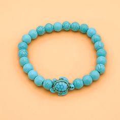 Simple and playful, the Sea Turtle Bead Bracelet reminds its wearers of blissful days at the beach. Warm up a loved one this holiday season by gifting her this beautiful keepsake. Details: White Turquoise Beads Turquoise Beads Amazonite Beads Turquoise Beads Bead Size 8mm in Diameter Stretchable Ocean-inspired Turquoise Bracelets For Vacation, Turquoise Ocean-inspired Beaded Bracelets For Beach, Ocean-inspired Turquoise Starfish Beaded Bracelets, Handmade Adjustable Turtle Bracelet, Adjustable Turtle Bracelet For Beach, Sea Turtle Bracelet, Turtle Bracelet, Turtle Design, White Turquoise