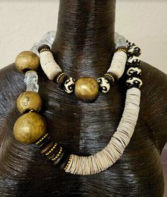 Women of Color will look fabulous in this exotic statement necklace set which can be worn together, separately or layered with your personal favorites. The asymmetrically set components add lots of interest and drama. I have another set done in similar colors which could be intermingled with this set for more styling variations (see the last photograph). The shorter strand adjusts from 16-19" while the longer strand adjusts from 25-28". Both are finished with silver tone hardware and lobster cla Unique Multi-strand Necklace With Variations, Bohemian Jewelry With Unique Design, Unique Gold Beaded Necklaces, Multi-strand Necklaces With Large Beads, Rocker Chic Accessories, Jewelry Vendor, Art Statement, Unique Pendant Necklace, Long Statement Necklace