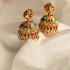 Discover Revati Antique Silver Jhumka Earrings | Paksha Bollywood Bridal Earrings With Intricate Design For Ceremonial, 22k Gold Jhumkas For Ceremonial Navratri, Ceremonial 22k Gold Jhumkas For Festive Occasions, Festive Ceremonial 22k Gold Jhumkas, Festive 22k Gold Jhumkas For Ceremonial Occasions, Festive Yellow Gold Jhumkas For Diwali, Bollywood Style Yellow Gold Jhumkas With Cutdana, Temple Jewelry Style Yellow Gold Jhumkas For Celebration, Elegant Navratri Jhumkas With Intricate Design