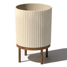 a white planter sitting on top of a wooden stand