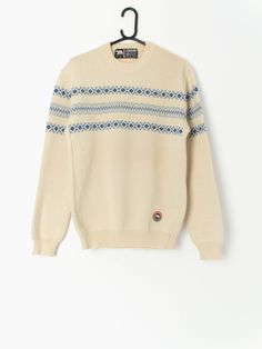 80s vintage Eisbär wool jumper in beige and blue, made in Austria. This jumper features a crew neck and an Eisbär embroidered logo on the bottom left of the jumper. Made in Austria from a heavy weight coarse wool, this jumper is ideal for staying toasty warm in the winter months. Our recommended size: Medium Label says: Medium to large Condition: Very good  Material: 100% pure new wool Measurements in inches: Pit to pit: 20 Shoulders: 18 Front length: 27.5 Back length: 27 Sleeve length: 25.5 Hem Retro Cotton Beige Sweater, Retro Beige Cotton Sweater, Beige Crew Neck Sweater, Cream Crew Neck Sweater For Winter, Cozy Beige Crew Neck Sweater, Cream Retro Winter Sweater, Vintage Crew Neck Sweater For Winter, Vintage Wool Crew Neck Sweater, Vintage Crew Neck Winter Sweater