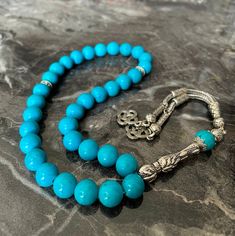 Product Details * Product Name : Real Turquoise 33 Beads Islamic Prayer Beads, Tasbeeh, Misbaha 10mm * Material : Real Turquoise Fairuz Stone Sibha * Bead Size : 10 mm (Approximately 0,39 Inches) * Bead : 33 pcs * Total Length : 310 mm (Approximately 12, 20 Inches) * Length without tassel : 200 mm (Approximately 7,87 Inches) * Colour : As the pictures show * Condition : 100% Brand New Note : The pictures show the real items without any special processing. But the color and brightness may differ Turquoise Rosary With Round Beads As Gift, Spiritual Turquoise Rosary With Round Beads, Traditional Polished Turquoise Beads, Turquoise Rosary With Round Beads, Blue Spiritual Rosary With Gemstone Beads, Turquoise Spiritual Polished Beads, Traditional Turquoise Genuine Beads, Natural Turquoise Stone, Islamic Prayer