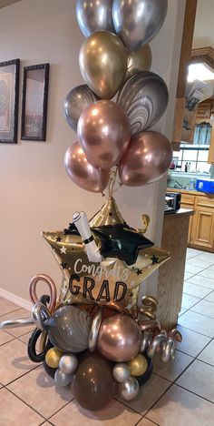 some balloons are stacked on top of each other in the shape of a graduation cap