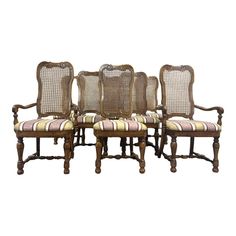 six chairs with cane back and striped upholstered seats