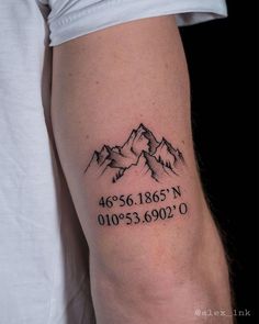 a man with a mountain tattoo on his arm that reads 46616's n