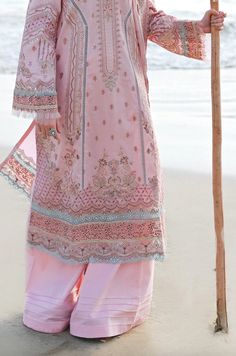 Description: This exquisite light pink 3 piece lawn Pakistani women's outfit from Qalamkar is the epitome of elegance and sophistication. The embroidered kurta is a stunning work of art, featuring intricate embroidery and delicate details. The outfit is completed with a digitally printed dupatta and wide leg plain lawn trouser. Materials: Shirt (Lawn) - Chikankari Gotta Embroidered with digital printingDupatta (Organza) - Digital Printed Embroidered Dupatta with laceTrouser (Lawn) - Plain Trouser *Disclaimer: Due to the many variations in monitors and browsers, the color of products may appear different on different monitors. **Additional decorative trim has been added to the outfit in the photos. The stitched outfit will not include the additional designer trim. Pakistani Boutique, Pakistani Designer Clothes, Printed Dupatta, Organza Dupatta, Embroidered Neckline, Pakistani Designers, Suit Fabric, 3 Piece Suits, Pakistani Outfits