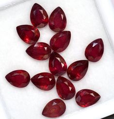 a group of red diamonds sitting on top of a white surface