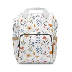 a white bag with flowers and leaves on the front, it's zippered closure