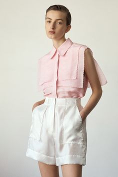 The Forget Me Not Sleeveless shirt in Rose is part of the PALMA MARTÎN 1_21 Most Serene collection. Beautifully lightweight, this nostalgic sailing inspired design is a collection favourite. The 2 layers of finely scalloped lapels on the front and back of the shirt, bring a serene softness to the overall look. The style has a concealed button front opening with a beautiful pearl button at the top of the placket. Relaxed fit silhouette. Model is wearing a Size 8 CARE INSTRUCTIONS Main: Linen / Si Sleeveless Workwear Shirt For Spring, Sleeveless Shirt For Spring Workwear, Elegant Sleeveless Summer Shirt, Elegant Sleeveless Shirt For Summer, Summer Collared Blouse For Layering, Summer Layering Pink Blouse, Spring Sleeveless Blouse, Sleeveless Blouse For Summer Layering, Chic Sleeveless Shirt For Summer