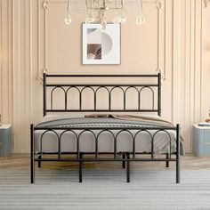 a bedroom with a metal bed frame and chandelier