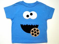 a blue t - shirt with a cookie monster on it's chest and eyes