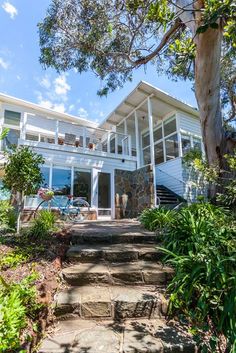 a white house with stairs leading up to it