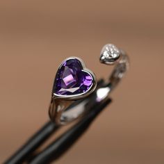 It is real natural amethyst ring, the heart amethyst gemstone is about 8mm*8mm. The basic metal is sterling silver and plated with rhodium. To change the metal to a solid gold (white/rose) or platinum is also available, please ask for a quotation if you want. You can also go to my shop Home for more elegant rings: https://www.etsy.com/shop/godjewelry?ref=hdr_shop_menu Amethyst is the birthstone of January. More amethyst rings: https://www.etsy.com/shop/godjewelry?ref=hdr_shop_menu&section_id Silver Heart-shaped Adjustable Crystal Ring, Adjustable Silver Heart-shaped Crystal Ring, Elegant Amethyst Heart-shaped Birthstone Ring, Elegant Purple Heart Ring For Anniversary, Fine Jewelry Heart-shaped Amethyst, Purple Heart Ring For Promise, Fine Jewelry, Elegant Amethyst Heart Promise Ring, Elegant Heart-shaped Amethyst Ring, Valentine's Day Purple Amethyst Sterling Silver Ring