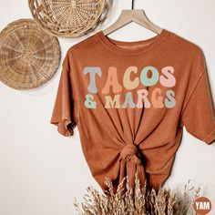 "Tacos And Margaritas Comfort Colors Shirt, Cinco De Mayo Fiesta Party Gifts, Margarita Shirts, Taco Lover Gift, Mexican Fiesta Party T-Shirt ✧ WHY  YOU'LL  LOVE IT ✧  ⋒ Comfort Colors® tees are garment-dyed shirts that are timeless classics and will never pile.  ⋒ Trendy retro vintage look and gorgeous colors.  ⋒ Amazingly soft and comfy. Perfect with any shorts, skirts, jeans, leggings, or nothing but undies around the house. ⋒ Created with quality in mind, it's made from 100% ring-spun cotton Fiesta Theme Outfits Women, Casual Cotton Shirt For Cinco De Mayo, Custom Print Long Sleeve Summer Tops, Casual Short Sleeve Shirt For Cinco De Mayo, Casual Multicolor Shirt For Cinco De Mayo, Custom Print Long Sleeve T-shirt For Summer, Casual Graphic Print Tops For Cinco De Mayo, Cinco De Mayo Funny Print Crew Neck Top, Cinco De Mayo Graphic Tee With Crew Neck