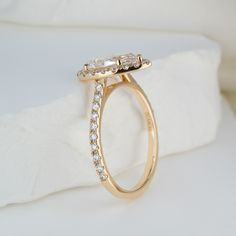 a diamond ring sitting on top of a white pillow