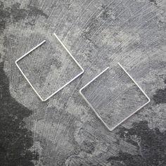 These Square Sterling Silver Minimalist Ear Cuffs are a modern on-trend innovative design ingeniously blending earring and ear cuff to give you a geometric designer look without the pain of multiple piercings! Up your ear game and mix and match different shapes for a really edgy style statement, or wear a pair as conventional drop earrings for a more classic approach to the design. Available singularly or as a pair, and in a variety of finishes. These versatile pieces also look wonderful worn in cartilage piercings! Made from: Sterling silver. Measurements: Earring Dimensions: approx. H3.0cm x W3.0cm Adjustable Modern Single Wrap Earring, Modern Adjustable Single Wrap Earring, Minimalist Metal Hoop Ear Cuff, Modern Single Ear Cuff As Gift, Modern Adjustable Cartilage Earrings With Ear Wire, Modern Geometric Metal Hoop Earrings, Modern Adjustable Cartilage Earrings For Everyday Wear, Modern Adjustable Ear Cuff As Gift, Modern Adjustable Single Cartilage Earring