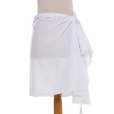 Handmade in Indonesia this short fashionable short sarong makes a perfect beach accessory. Artisan Prayascita Dewi crafts the attractive piece from white 100% rayon. White Wrap Cover-up For Beach Party, White Sarong For Summer Beach Cover-up, White Wrap Swimwear For Summer, White Cotton Swimwear For The Beach, Casual White Sarong For Beach, White Casual Sarong For Vacation, White Wrap Swimwear For Beach Season, White Cotton Summer Cover-up, Summer White Cotton Cover-up