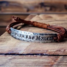 Hand-stamped adjustable bracelet made with: -Your choice of Fine Pewter or Copper -Genuine Leather  Copyright © 2022 DESIGNbyANCE All rights reserved Adjustable Brown Metal Wrap Bracelet, Bohemian Personalized Adjustable Bracelets, Adjustable Brown Metal Bracelet, Adjustable Brown Metal Bracelets, Bohemian Adjustable Personalized Bracelets, Bohemian Hand Stamped Bracelets For Gift, Bohemian Hand Stamped Bracelets For Gifts, Handmade Adjustable Meaningful Bracelets, Bohemian Hand Stamped Bracelets As Gift