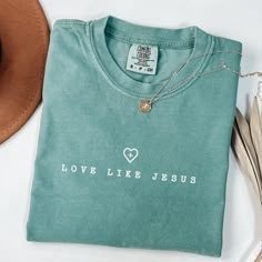 Are you a Jesus lover searching for the perfect gift? Look no further! Our faith-based apparel is designed to inspire and uplift those who follow Christ. Introducing our collection of faith-based shirts, a must-have for every Christian.  Product Info Comfort Colors Brand Shirt: 100% ring-spun cotton Care Instructions: Machine wash: cold (max 30C or 90F) Tumble dry: low heat Iron, steam or dry: medium heat Do not dry clean Production Time: Please allow 1 to 5 business days for production Delivery Jesus Loves You Shirts, Green Tops With Screen Print For Gift, Green Screen Print Top As A Gift, Green Screen Print Top As Gift, Green Letter Print Top As A Gift, Green Letter Print Top As Gift, Inspirational Crew Neck Top As Gift, Inspirational Letter Print Top As Gift, Christian Wear