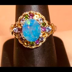 Stunning Oval Cut Fire Blue Opal With Multi-Color Brilliant Cut Topaz Stones Ring! Really Beautiful Blending Of Cut And Colors In This Two Tone 925/Gp Decorative Halo Style Ring. Size 8. Nwot. Blue Multi-stone Opal Ring Fine Jewelry, Oval Blue Multi-stone Gemstones, Blue Oval Multi-stone Gemstones, Elegant Multi-stone Sapphire Birthstone Ring, Elegant Sapphire Multi-stone Birthstone Ring, Blue Gemstones With Accents Fine Jewelry, Fine Jewelry Multicolor Multi-stone Opal Ring, Elegant Sapphire Birthstone Ring With Multi-stone, Sapphire Multi-stone Birthstone Ring