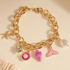 Pink Seashells, Pearls, And Gold Charm Bracelet For Sale! This Charm Bracelet Is New And Is From My Boutique! It Has Beautiful Shell Charms That Are Dangling From A Gold Chain! The Chain Is Made Out Of Stainless Steel. It Is Just Over 7 Inches Long When Unclasped. Such A Great Bracelet To Add To Your Jewelry Collection! Measurements: Bracelet Length: 7.2 Inches Pink Metal Charm Bracelet With Charms, Pink Metal Charm Bracelet, Trendy Pink Metal Bracelets, Trendy Pink Metal Bracelet, Pink Bracelet With Lobster Clasp For Party, Pink Metal Bracelet With Charms, Adjustable Pink Metal Charm Bracelet, Pink Metal Bracelets For Party, Pink Metal Bracelets With Charms