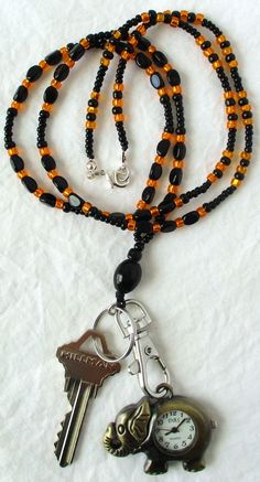 This orange & black beaded lanyard, can be used as a badge holder, an I.D. holder, keychain necklace, watch holder - it's a multi-use accessory for home or office! 34" in length, made with glass beads, beading cord, metal lobster clasp, clip, and keyring. Snap on badge holder included with every lanyard purchase. This orange & black beaded lanyard ships to you in a gift box, ready to give as a present or to keep and store. Note: Watch not included with purchase. Back to Beaded Lanyards Everyday Black Beaded Jewelry, Adjustable Black Lanyard With Key Clip, Adjustable Black Lanyards With Key Clip, Black Beaded Adjustable Lanyards, Adjustable Black Badge Holder With Key Leash, Black Beaded Lanyard As Gift, Handmade Black Lanyards, Black Beaded Lanyards As Gift, Black Beaded Lanyards For Gift