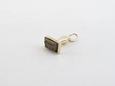 "Fabulous 14k Yellow Gold Vinatge Rubber Stamp Charm Material: 14k gold , Tested and stamped Length: 1/2\" long not including the bail Width: 3/8\" wide  Weight: 1.9 grams Oneille clark is written on the rubber stamp. Gift box include Images are enlarged to show details. They may appear larger than they appear in the photos. Please read description before the purchase. I ask you earnestly to make sure about measurements such as size , thickness, and length. Should you have any concerns or questi Stamped Yellow Gold Brass Jewelry, Classic Stamped Gold Jewelry, Bronze Stamped Jewelry For Anniversary, Classic Stamped Rectangular Jewelry, Rectangular 14k Stamped Yellow Gold Jewelry, Yellow Gold 14k Stamped Rectangular Jewelry, Classic Stamped Pendant Jewelry, Stamped Gold Pendant Jewelry, Stamped Rectangular Jewelry For Wedding