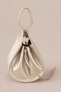 Metallic pearl corded bucket bag with corded handle. - Aza Fashions Elegant Handheld Bucket Bag, Cream Bucket Bag With Detachable Handle For Evening, Evening Cream Bucket Bag With Detachable Handle, Elegant Bucket Bag With Braided Double Handles, Handheld Beige Bucket Bag For Evening, Cream Evening Bucket Bag In Pouch Shape, Cream Evening Bucket Bag Pouch, Elegant Tote Bucket Bag With Braided Handles, Elegant Evening Bucket Bag With Braided Handles